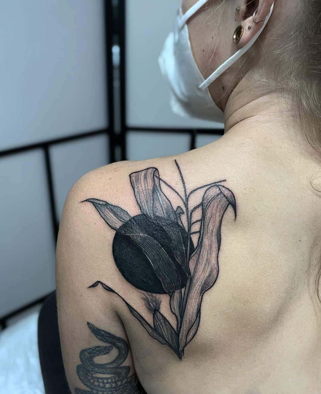 Black Circle and Plant Tattoo