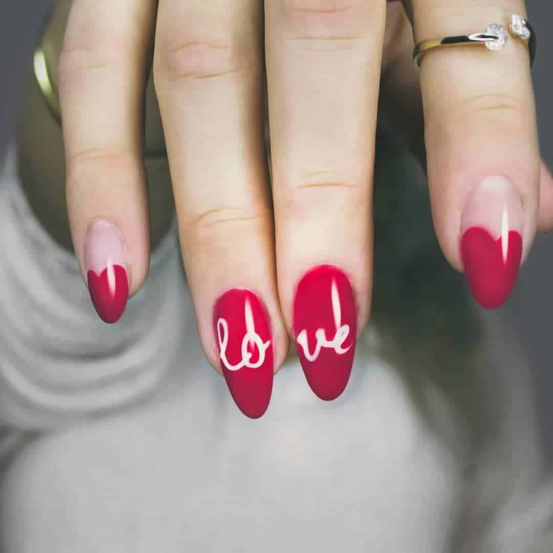 “Love” on Red Nails With Heart Accents